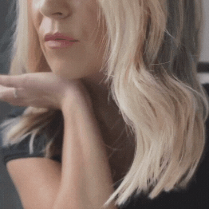 Woman demonstrating how to use our Roll-On Fragrance.