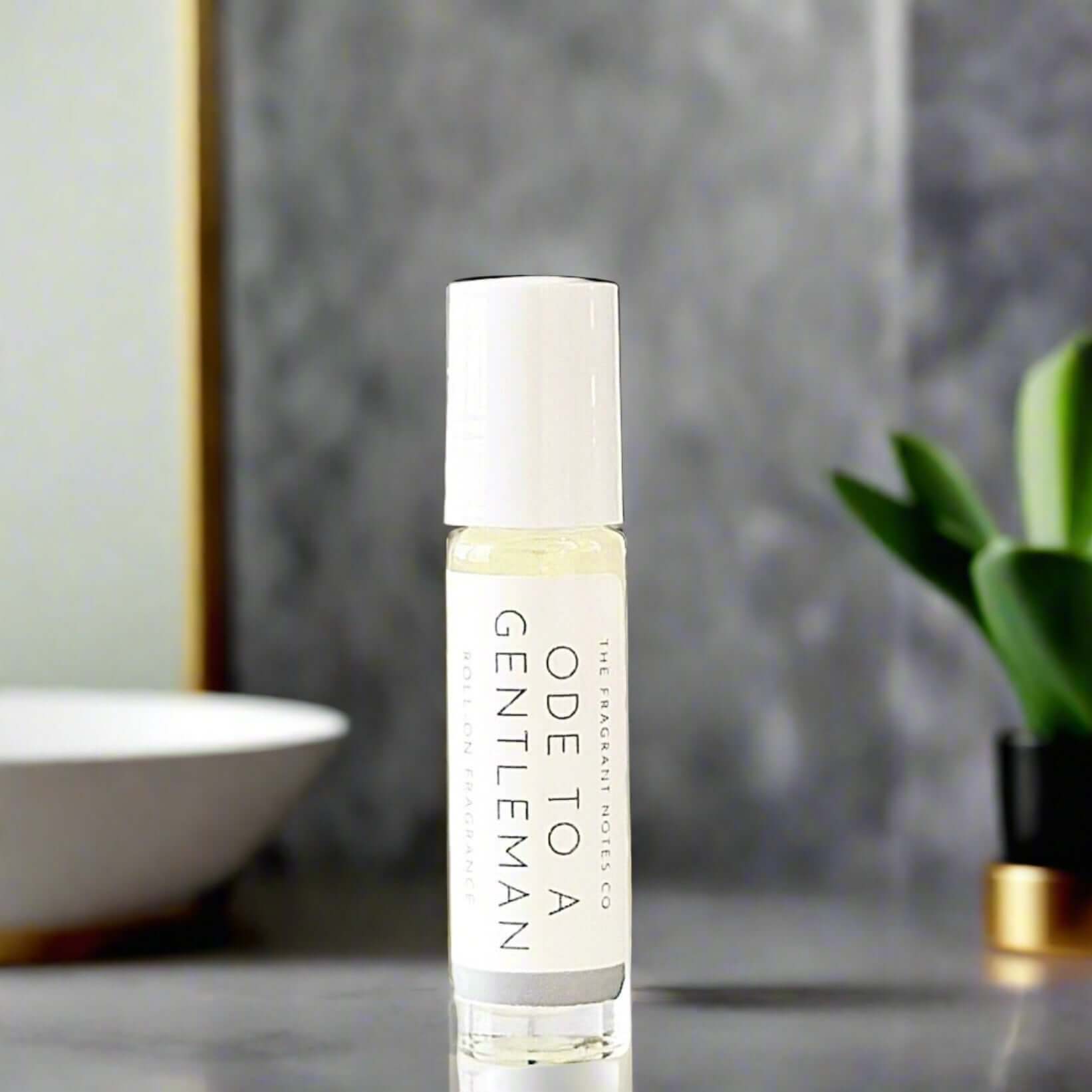 Ode To a Gentleman Roll-On Fragrance on a marble grey bathroom countertop.