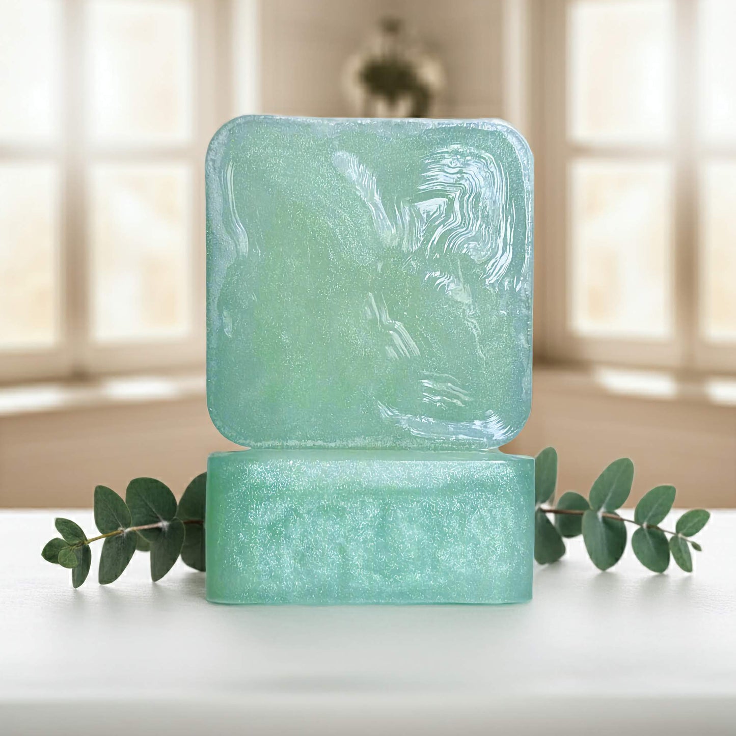 Cool Cadence green soap bars front and side sitting on white counter with green plant.