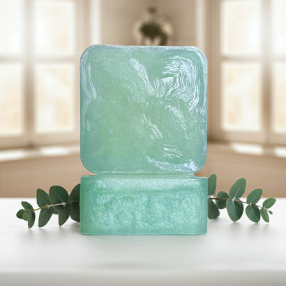 Cool Cadence green soap bars front and side sitting on white counter with green plant.