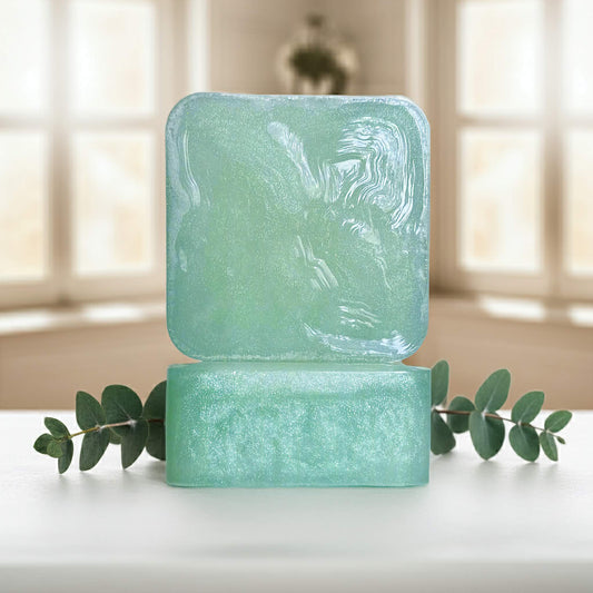 Cool Cadence green soap bars front and side sitting on white counter with green plant.