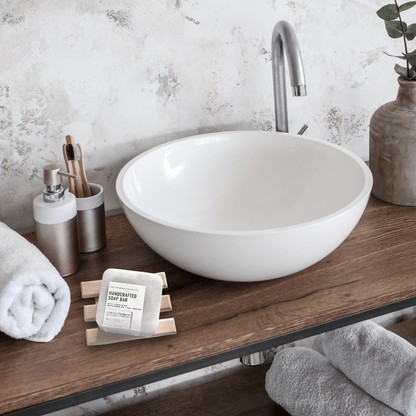 Our Natural Wood Slatted Soap Saver dish sitting on a wooden countertop in a modern bathroom.